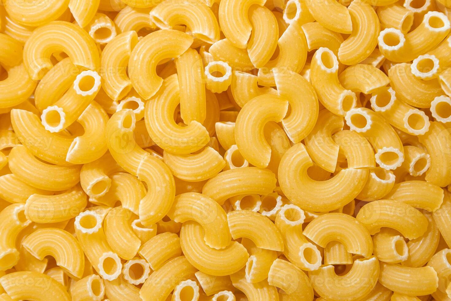 Uncooked Chifferi Rigati Pasta. A Culinary Canvas of Chifferi Rigati, Creating a Lively and Textured Background for Gourmet Cooking. Dry Pasta. Raw Macaroni - Top View, Flat Lay photo
