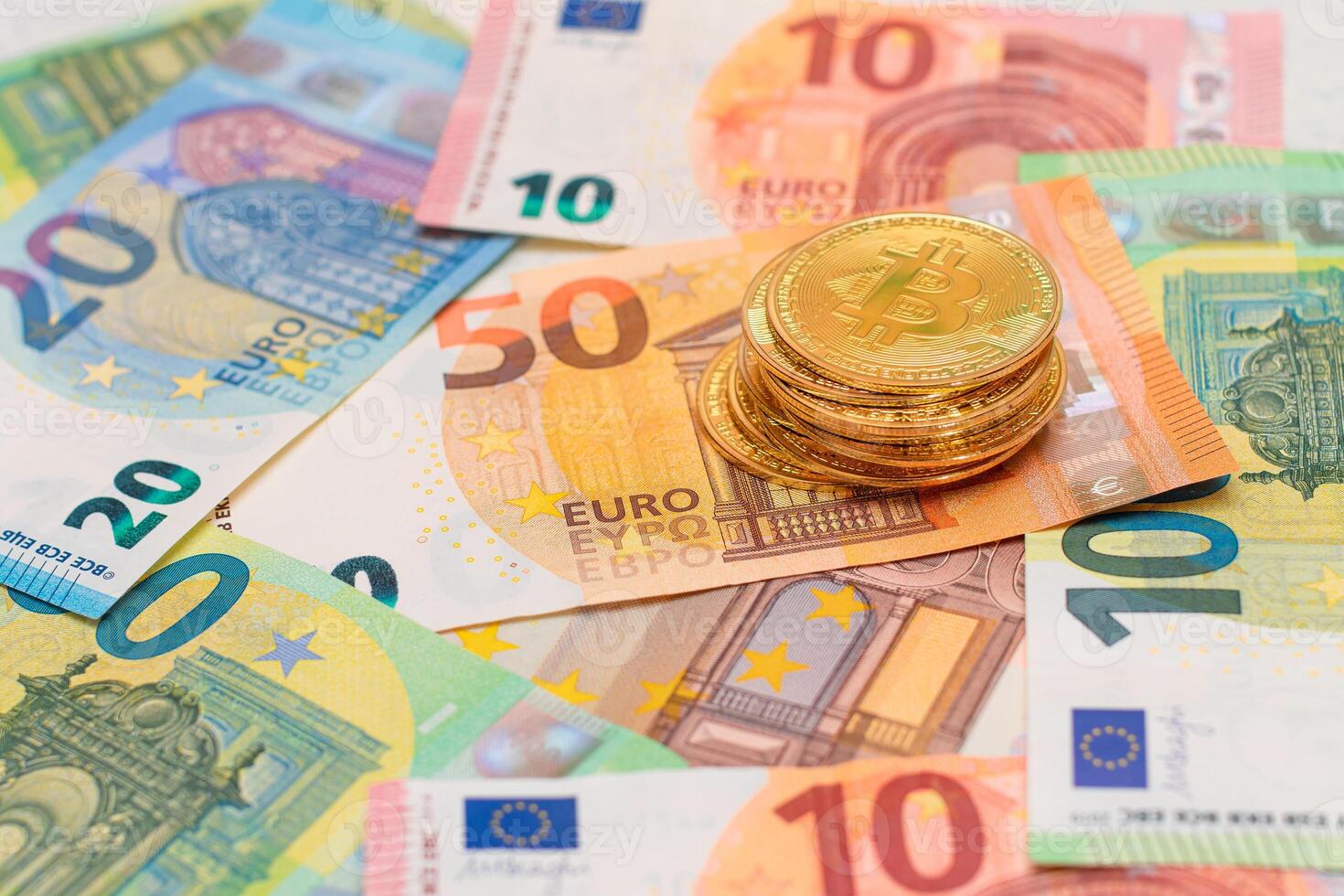 A Stack of Bitcoin Coins on the Euro Banknotes. Money Saving, Cryptocurrency, Blockchain and Anonymous Payments Concept photo
