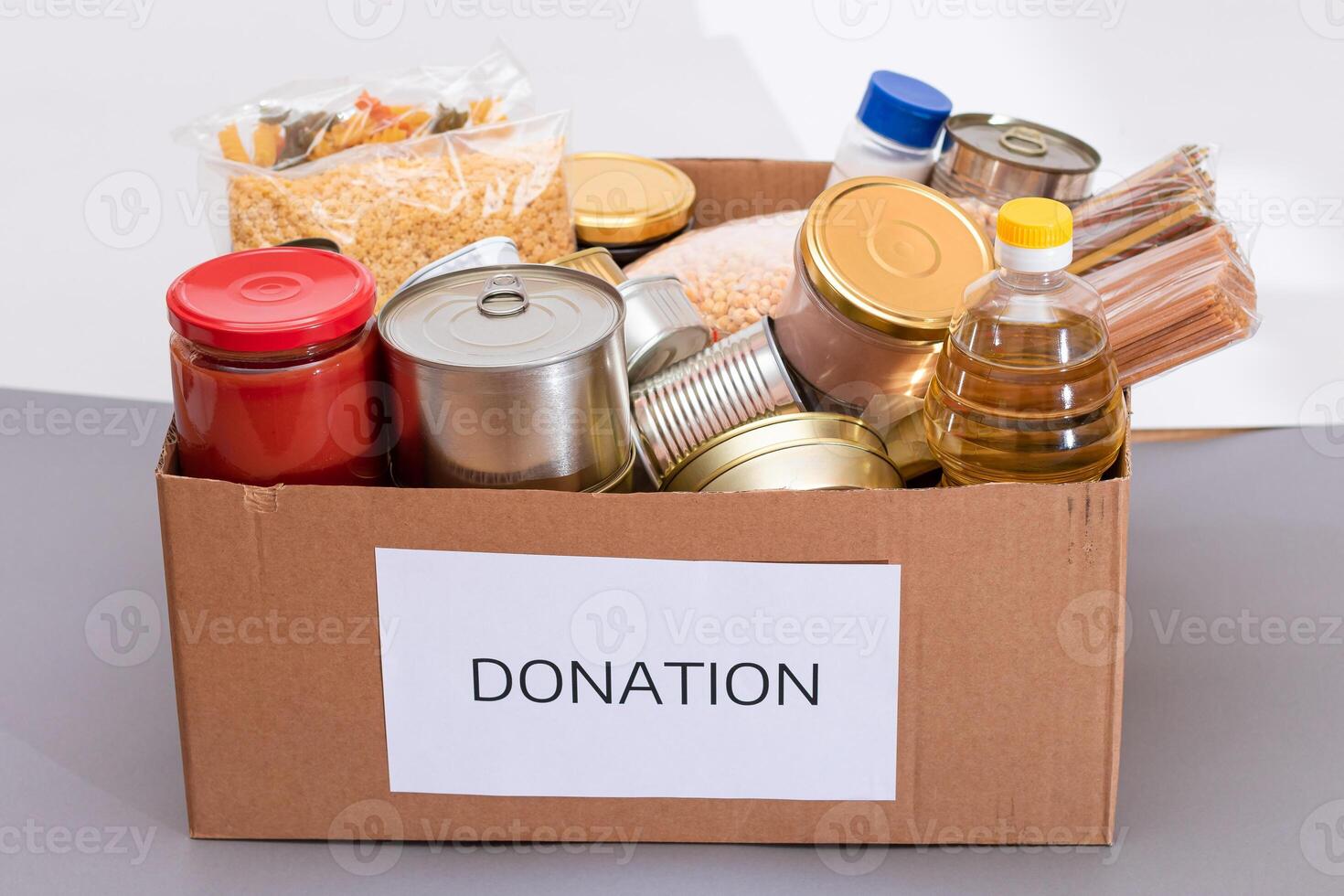 Donation Box of Free Food. Carton Box with Canned Food, Cereals and Grocery. Meal Reserves. Emergency Food Storage in Case of Crisis. Free Social Help, Blessings and Care. Strategic Food Supplies photo
