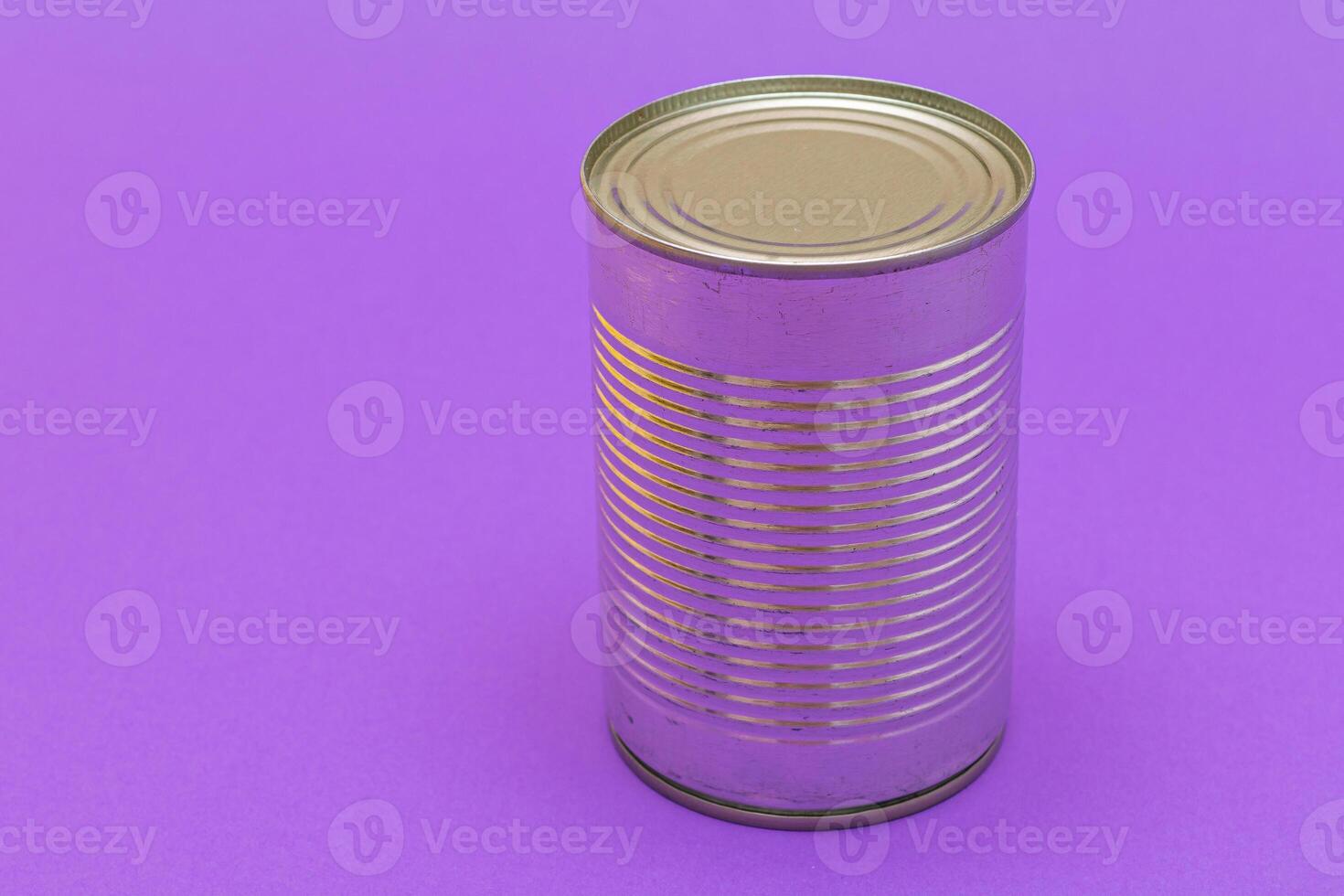 Unopened Tin Can with Blank Edge on Violet Background. Canned Food. Aluminum Can for Safe and Long Term Storage of Food. Steel Sealed Food Storage Container photo