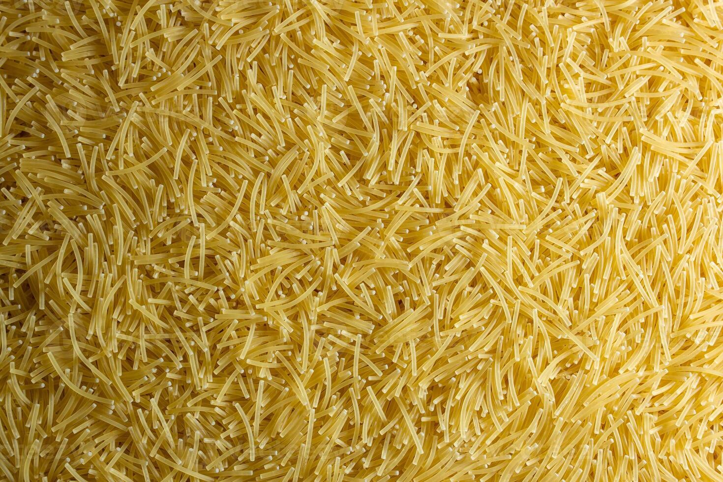 Uncooked Filini Pasta. A Culinary Canvas of Noodles, Creating a Lively and Textured Background for Gourmet Cooking. Dry Pasta. Raw Macaroni - Top View, Flat Lay photo