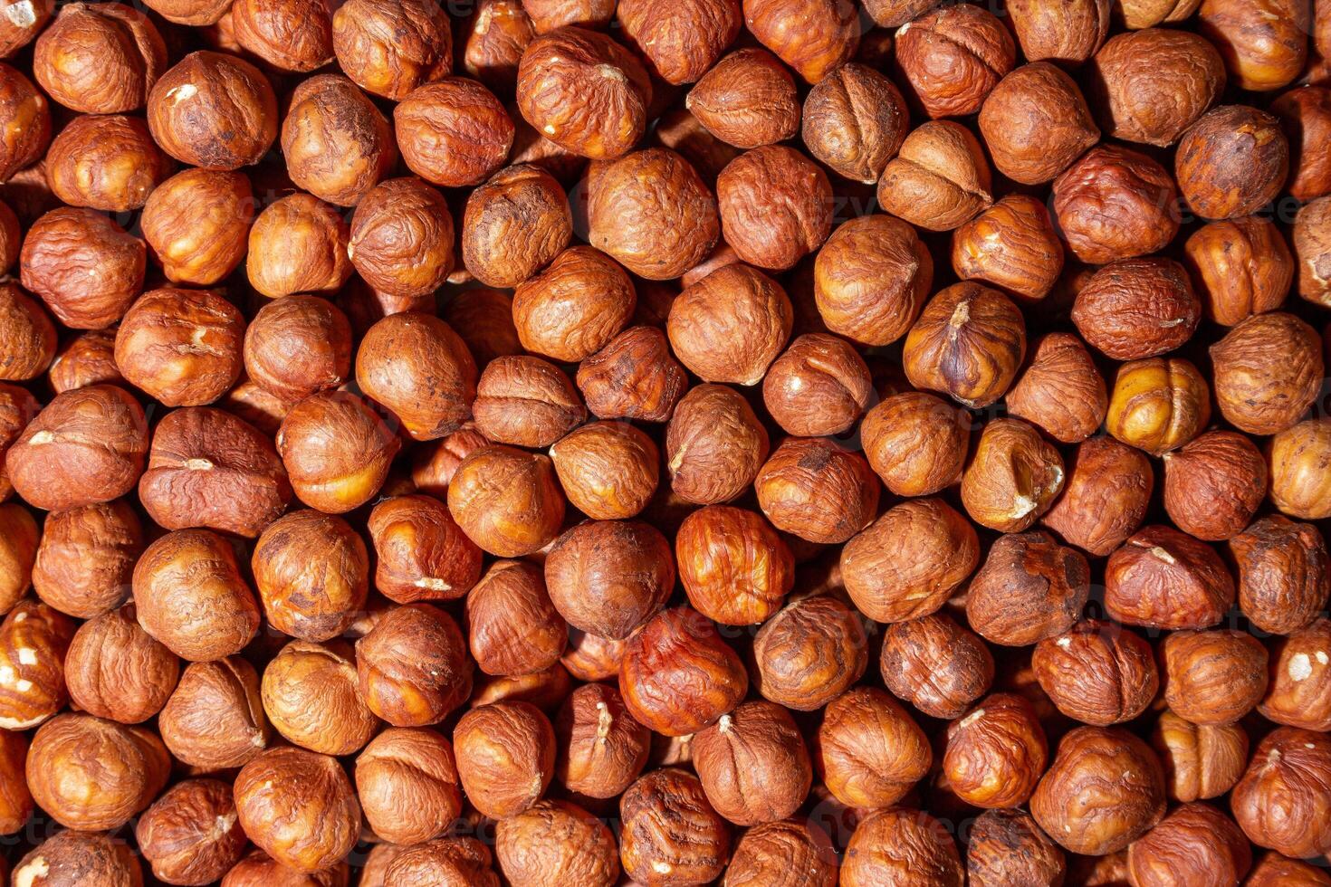 Scattered Peeled Hazelnut - Top View. Background from Hazelnuts. Natural High-Calorie Snacks photo