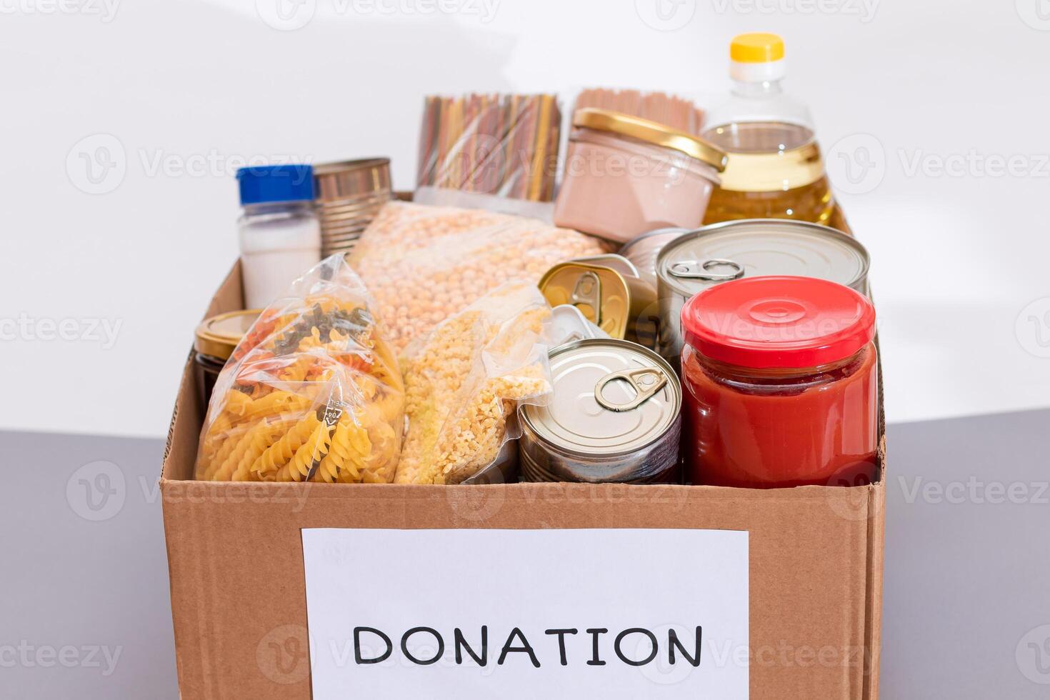 Donation Box of Free Food. Carton Box with Canned Food, Cereals and Grocery. Meal Reserves. Emergency Food Storage in Case of Crisis. Free Social Help, Blessings and Care. Strategic Food Supplies photo