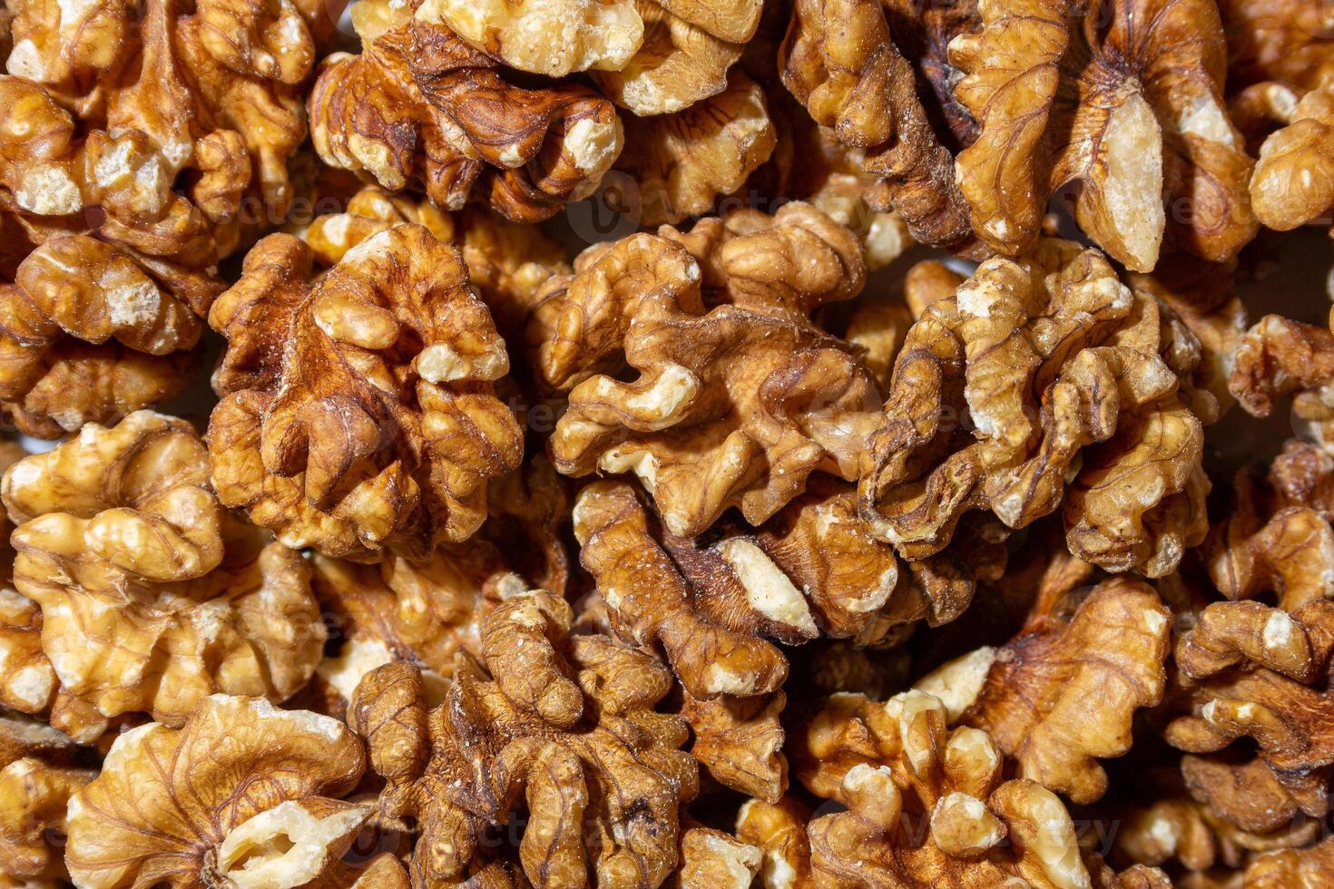 Scattered Shelled Walnuts. Background from Walnut. Natural High-Calorie Snacks photo
