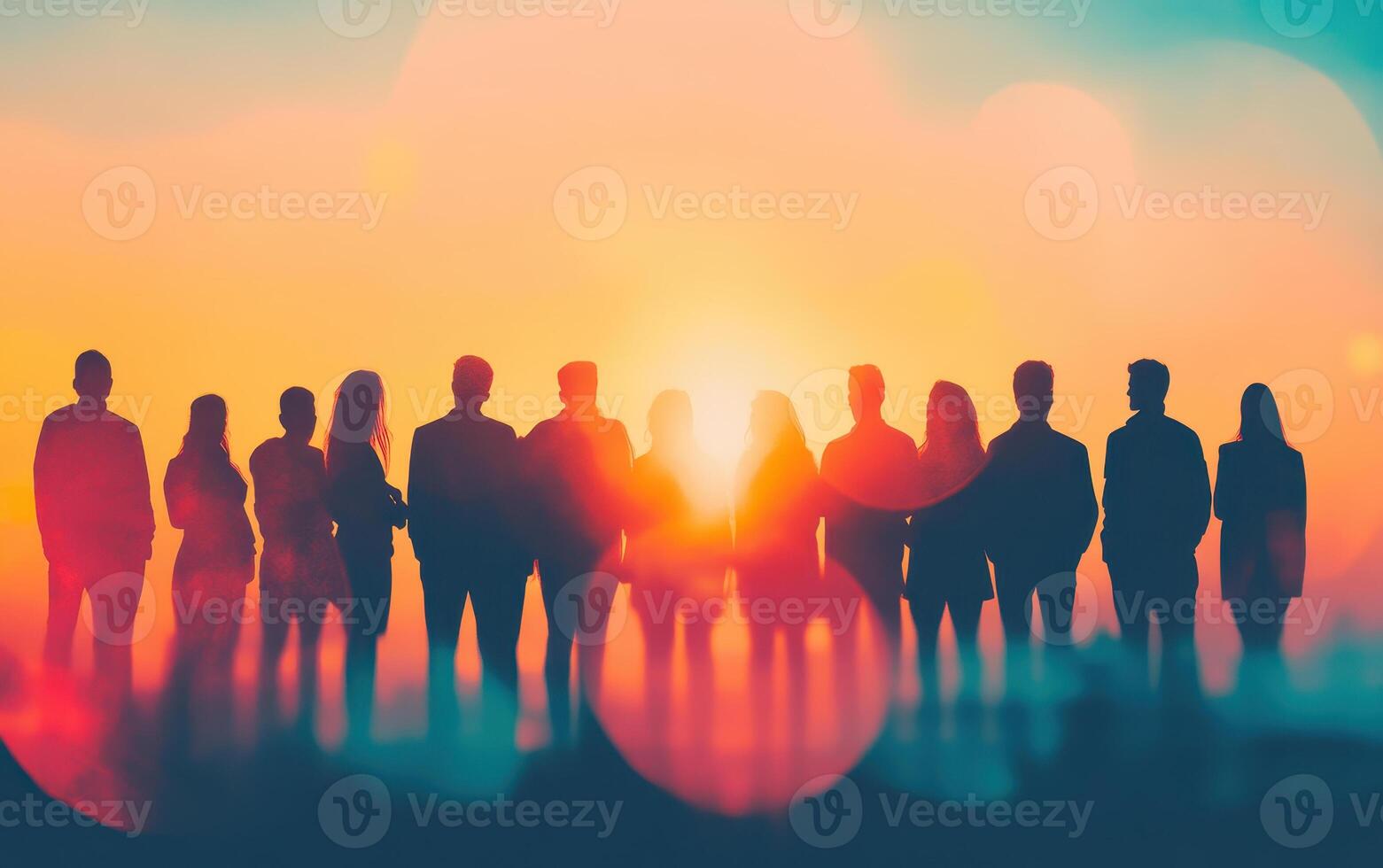group of colleagues standing together against vibrant sunset, showcasing teamwork and collaboration. silhouettes create striking visual against colorful backdrop photo