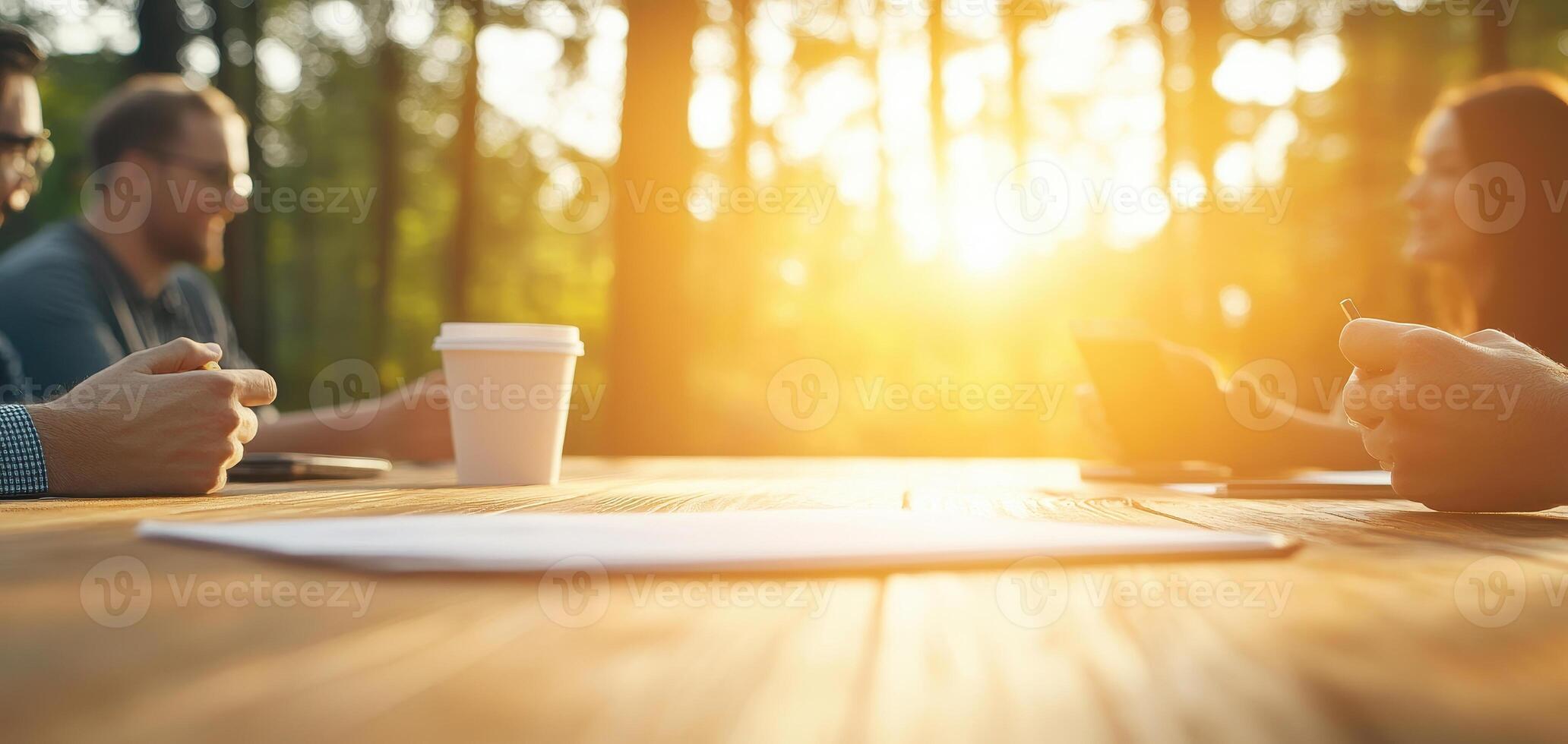 Collaborative team meeting outdoors, discussing strategies with coffee. warm sunlight creates positive atmosphere for brainstorming and teamwork photo