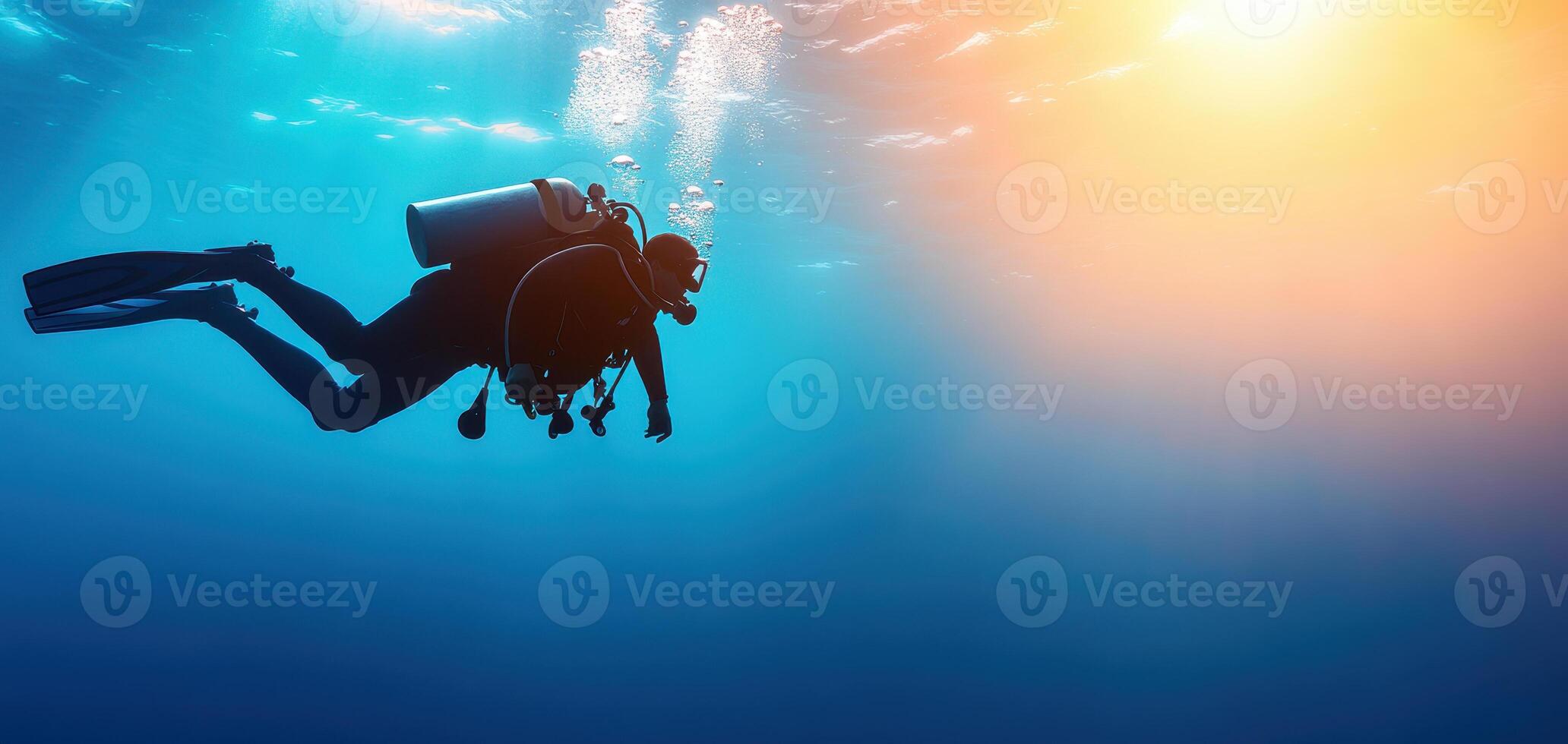 Diver exploring deep blue waters, surrounded by vibrant marine life and sunlight filtering through surface, creating serene underwater atmosphere photo