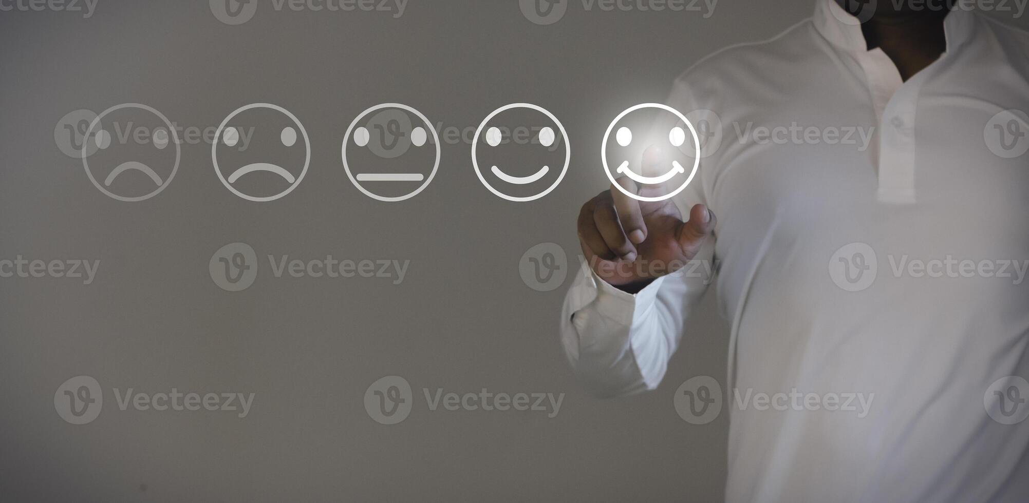 Business people are touching the virtual screen on the happy face icon to give satisfaction in service. Customer service and Satisfaction concept. photo