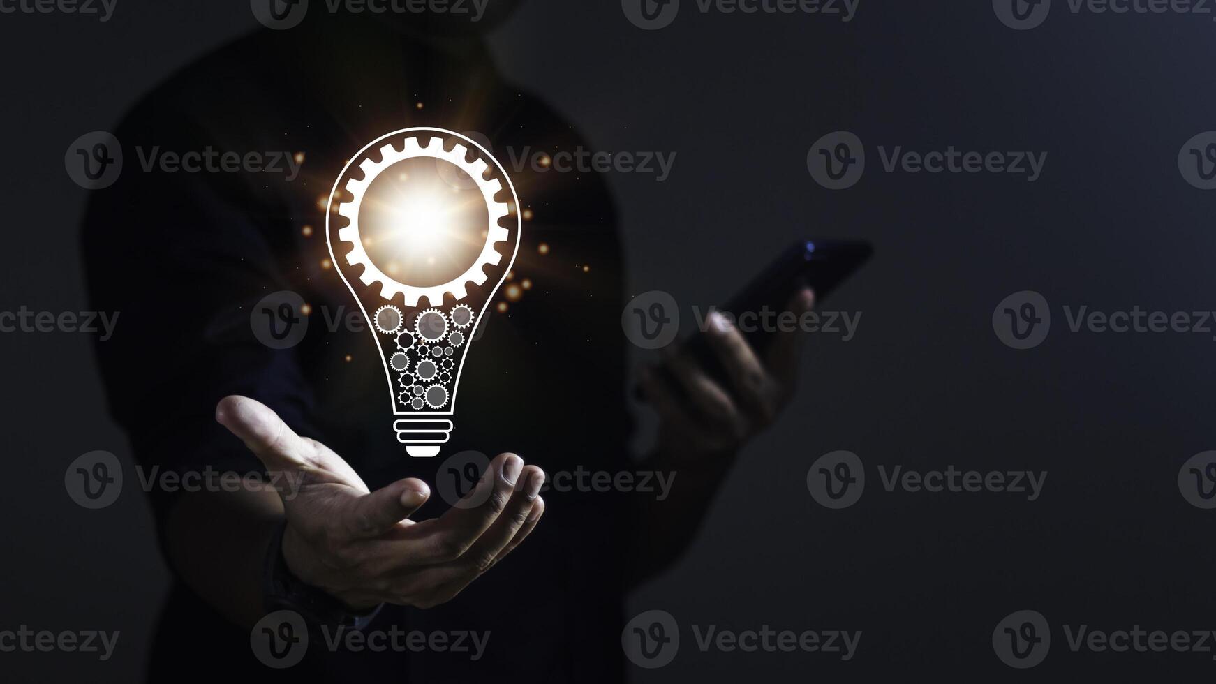 Businessman using smartphone and showing new idea with light bulb on hand for innovation and inspiration. photo