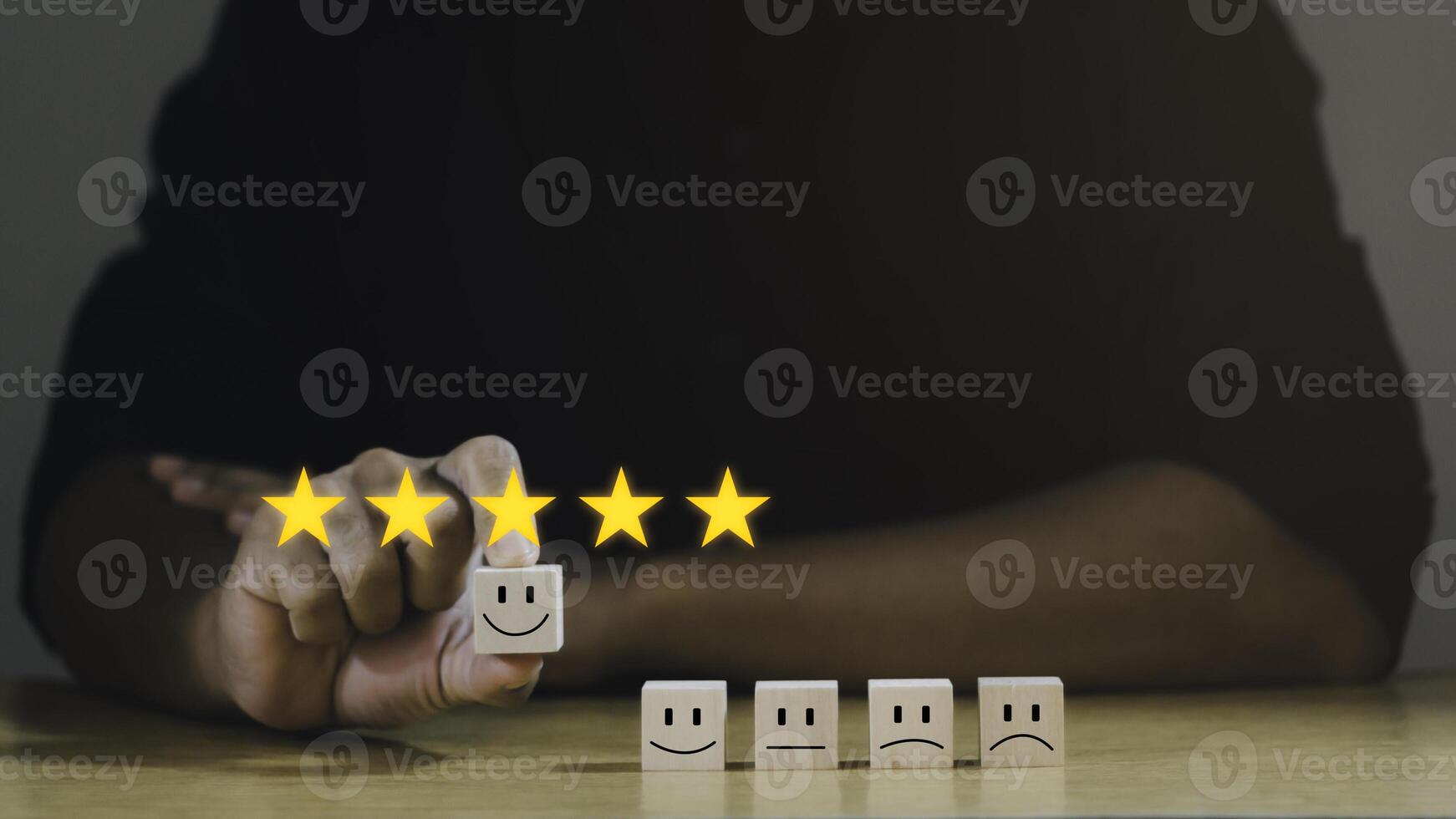 Customer services best excellent business rating experience. Satisfaction survey concept. Businessman chooses a happiest face on wood block. 5 Star Satisfaction. photo