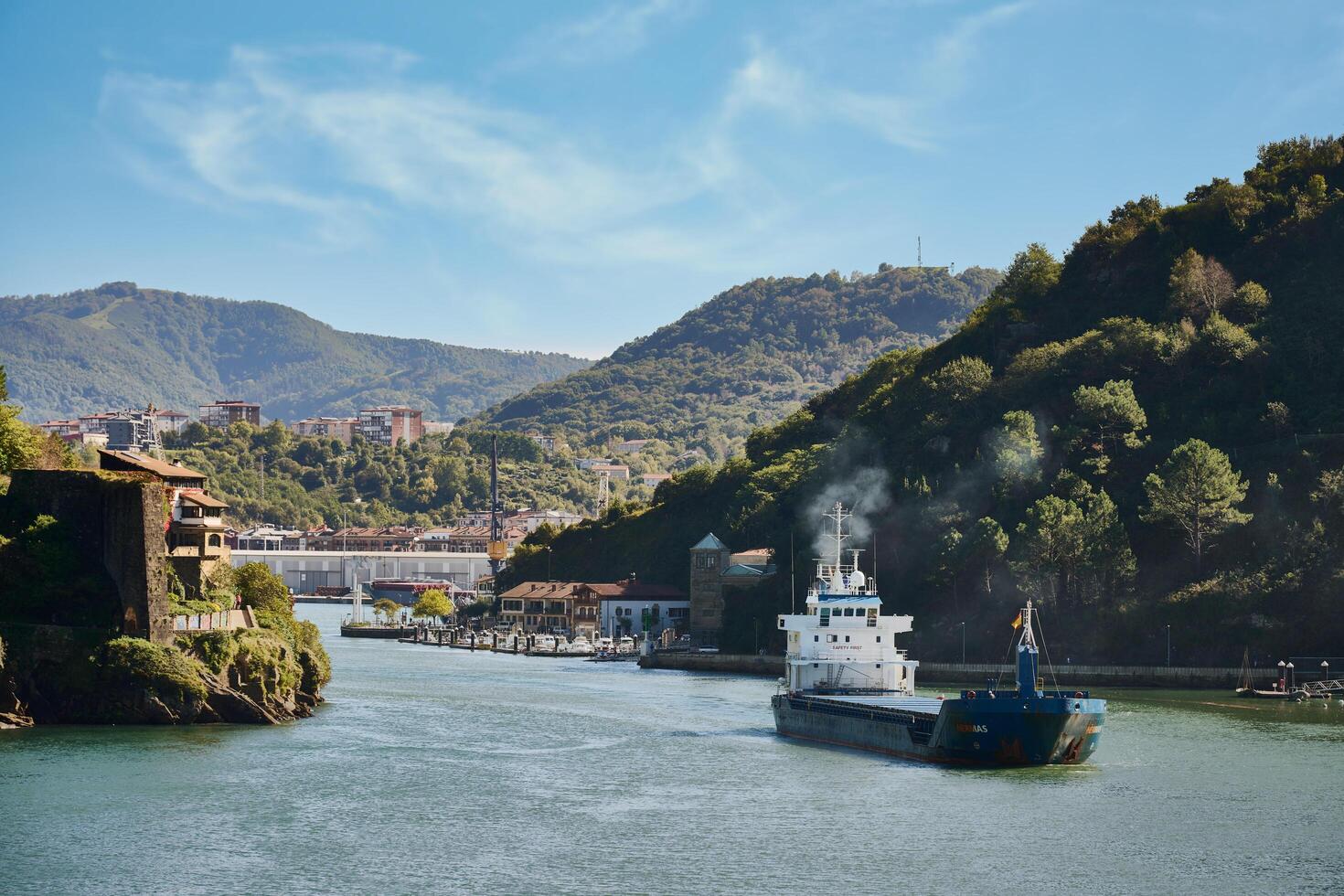 Pasaia, Guipuzcoa, Spain, 2024, View of a cargo ship leaving the port of Pasaia photo
