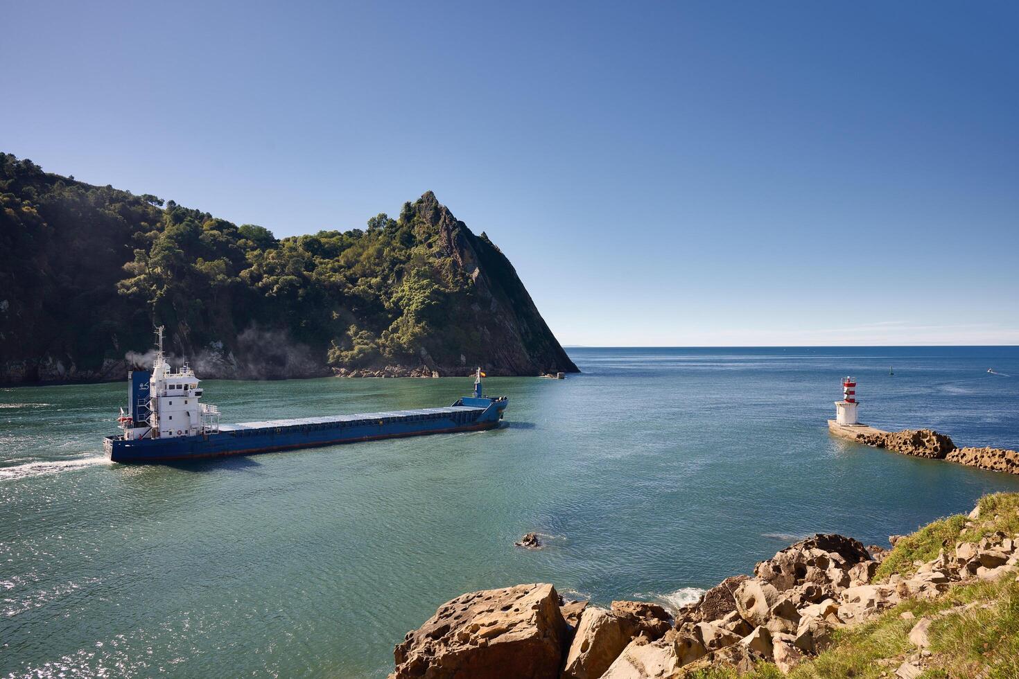 Pasaia, Guipuzcoa, Spain, 2024, View of a cargo ship leaving the port of Pasaia photo
