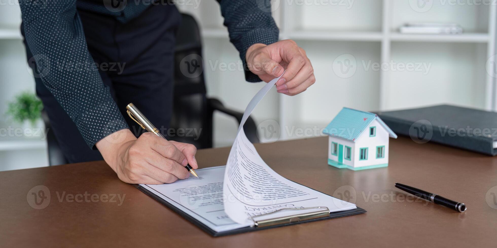 Real Estate Agent Signing a Property Contract for Client Representation photo