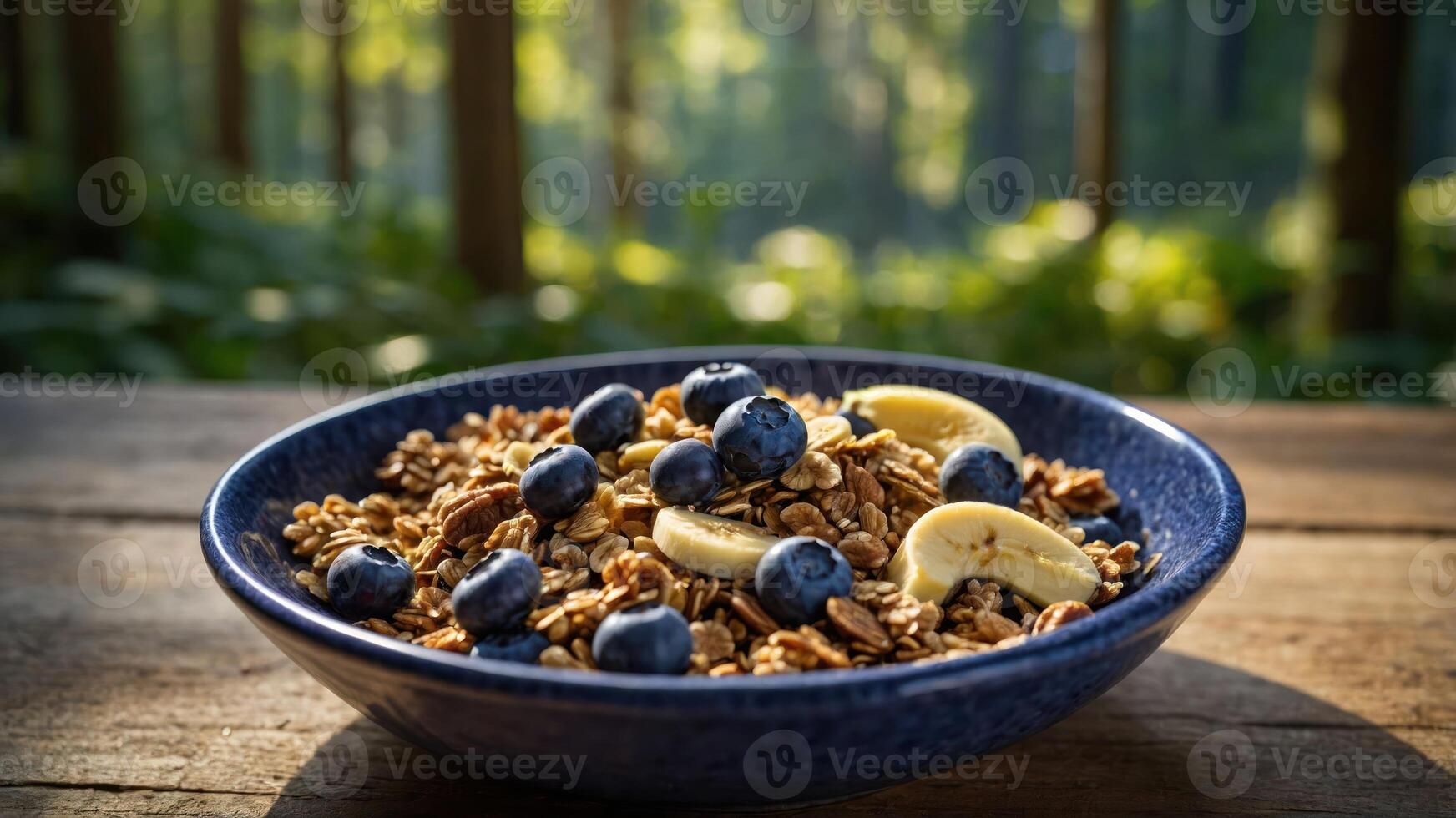 A bowl of granola topped with blueberries and banana slices, set in a natural forest environment. photo