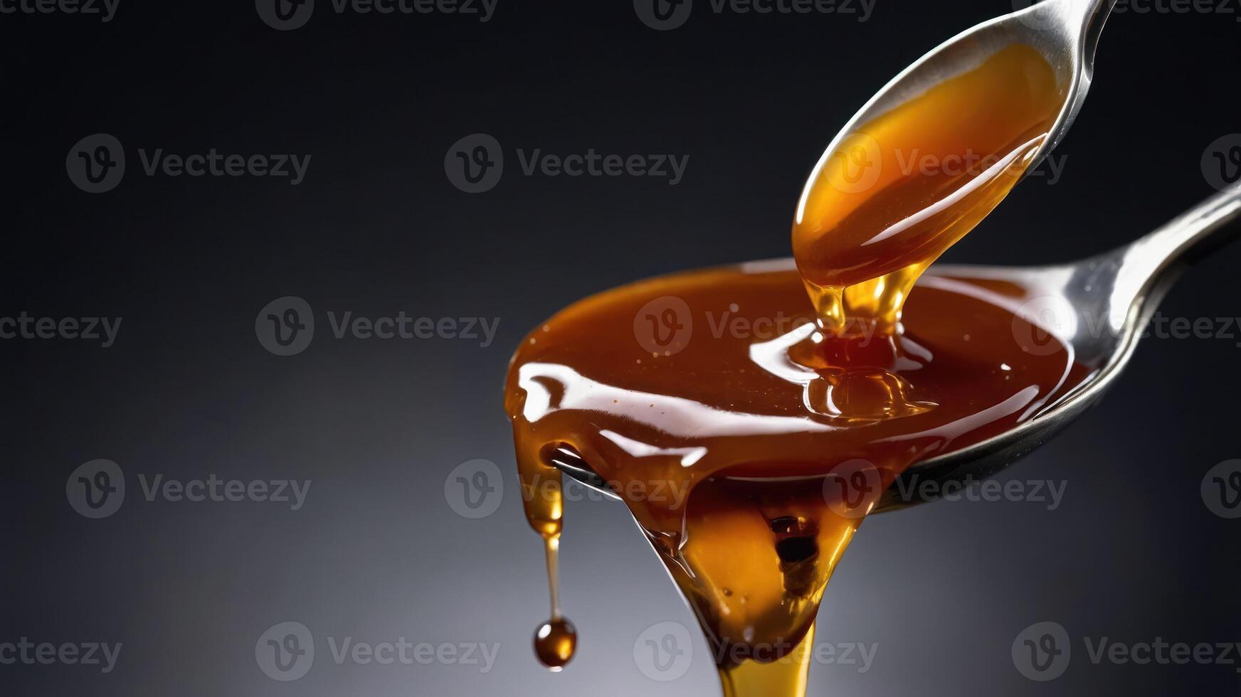 A spoonful of thick, golden syrup dripping gracefully. photo