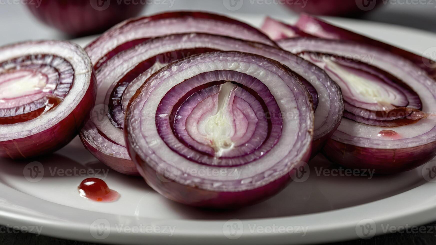 Sliced red onions arranged on a plate, showcasing their vibrant colors and textures. photo