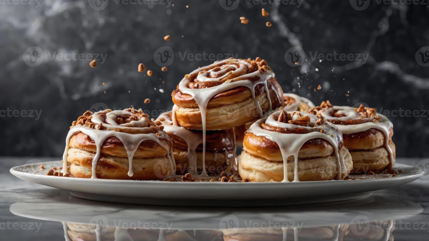 A tempting display of cinnamon rolls topped with icing and nuts on a plate. photo
