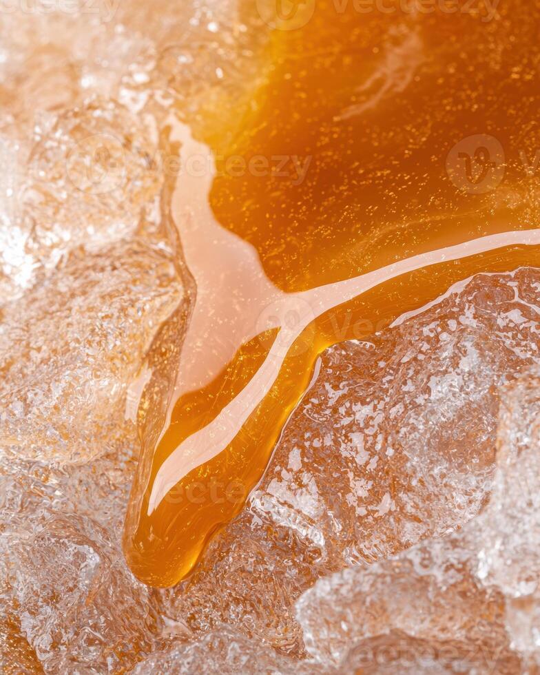 Close up of golden honey dripping from a honeycomb photo