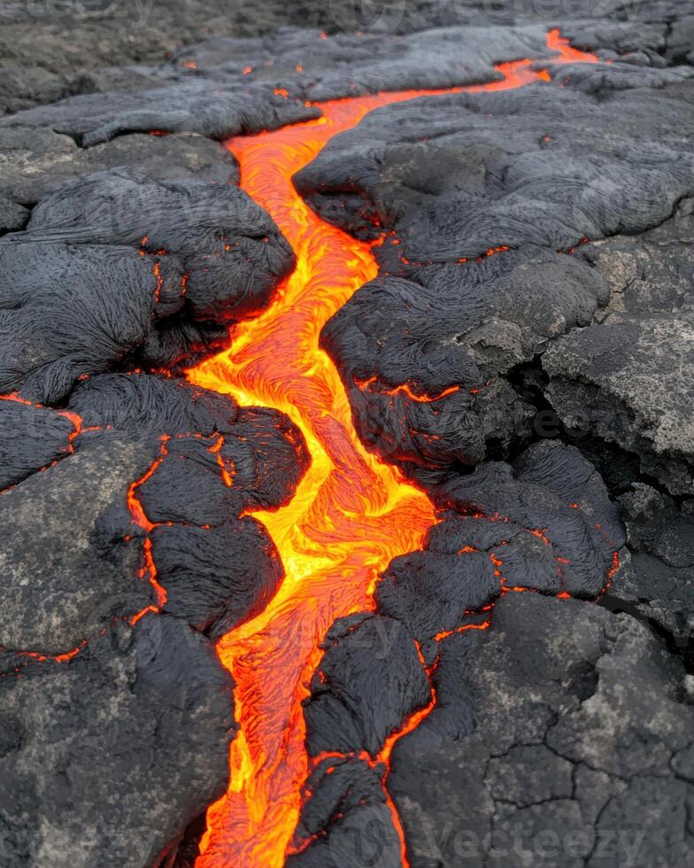 Flowing lava stream on volcanic surface photo