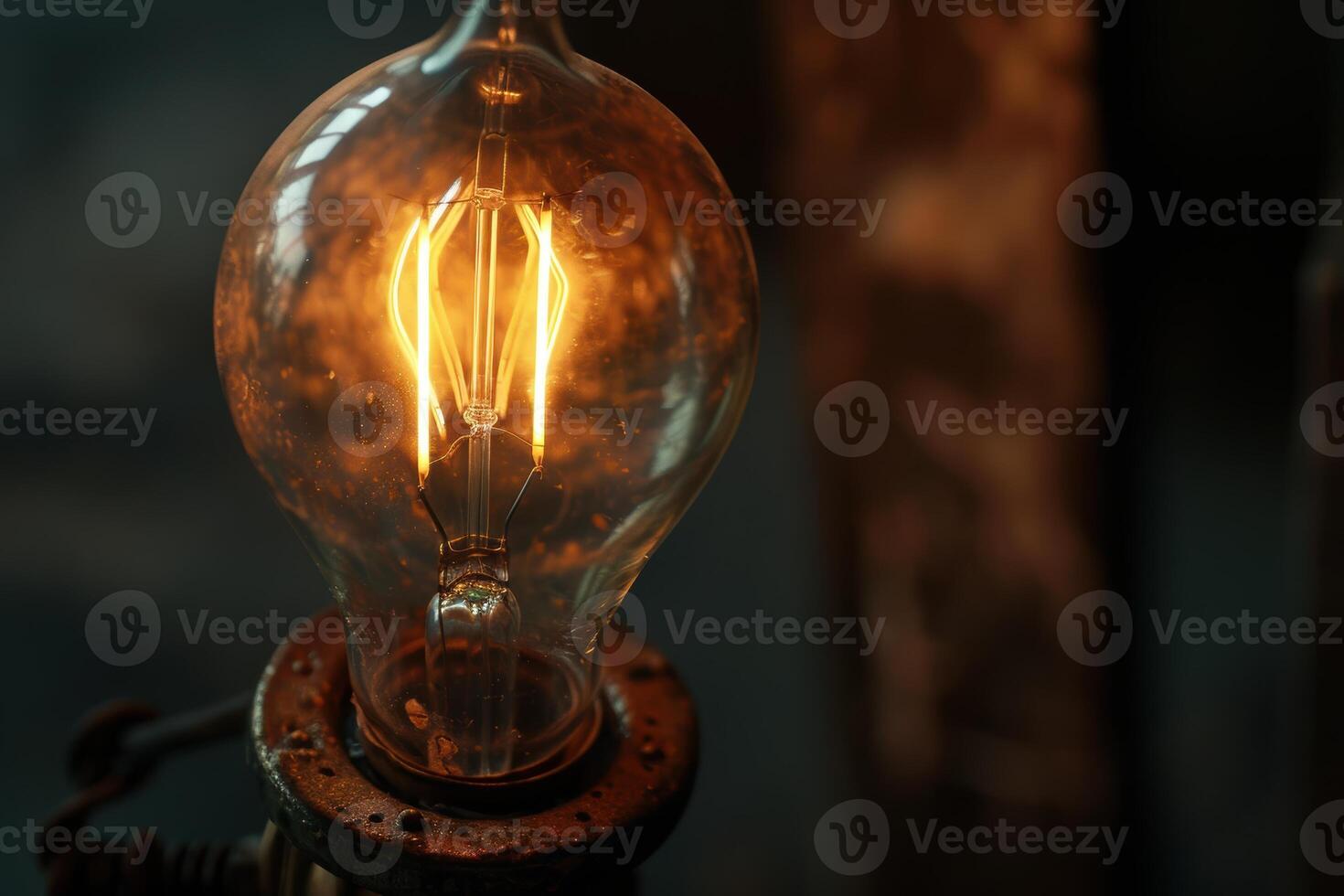 Glowing vintage light bulb in dark setting photo