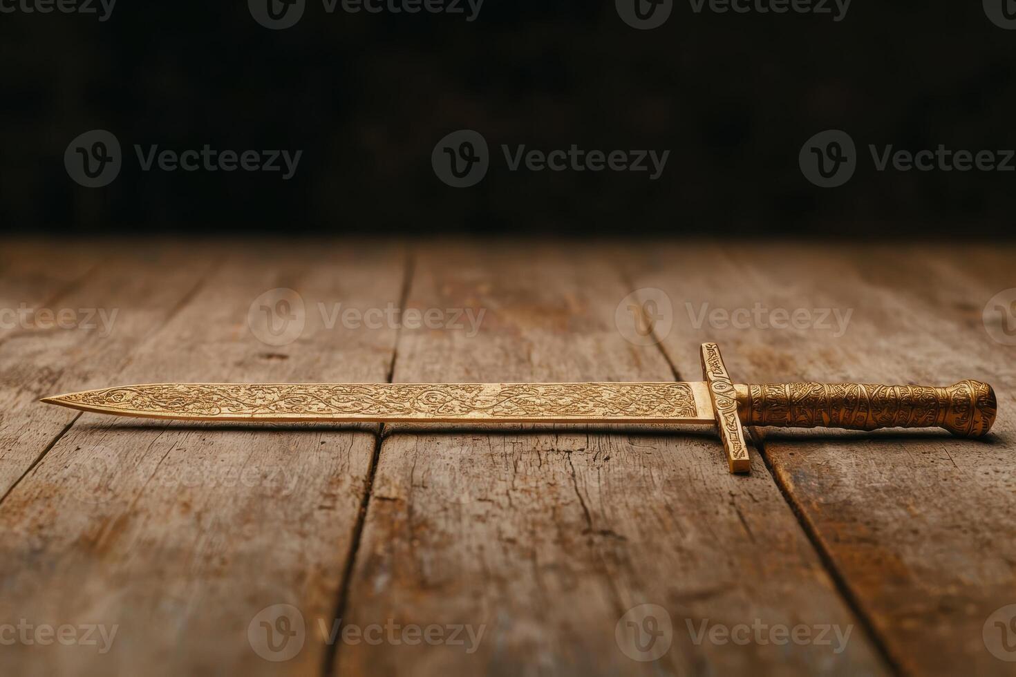 Ornate golden sword on wooden table photo