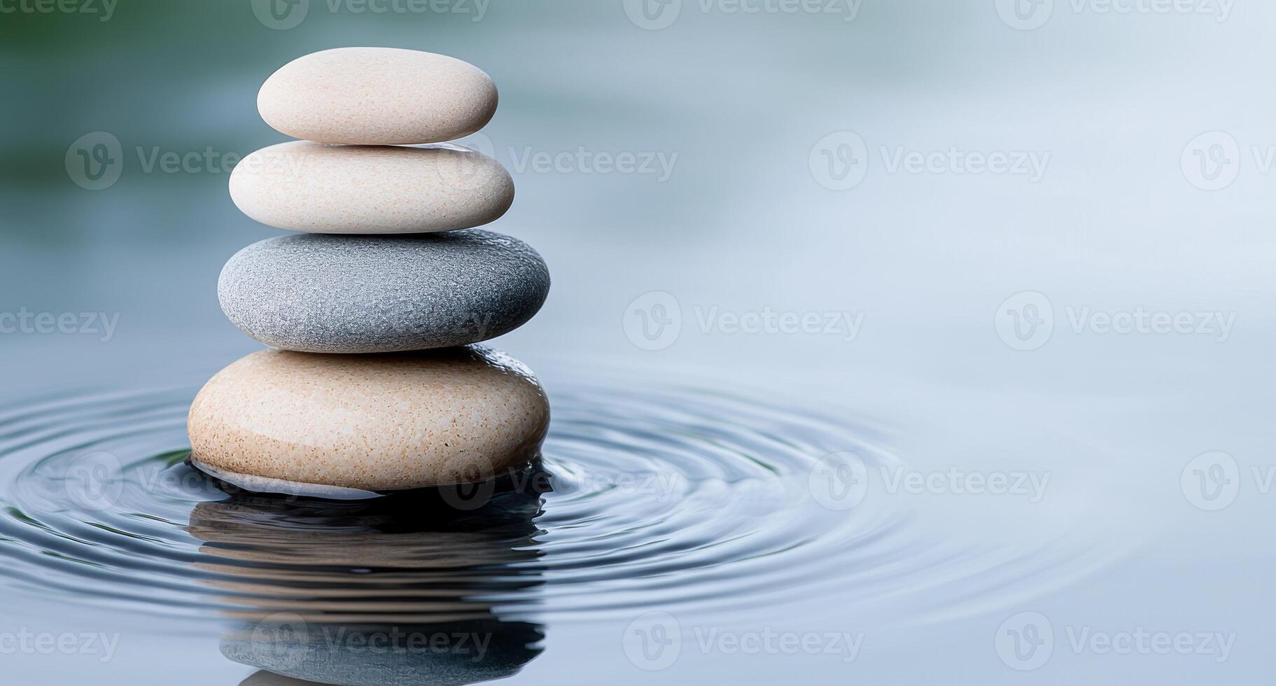 Balanced zen stones in water with ripples photo