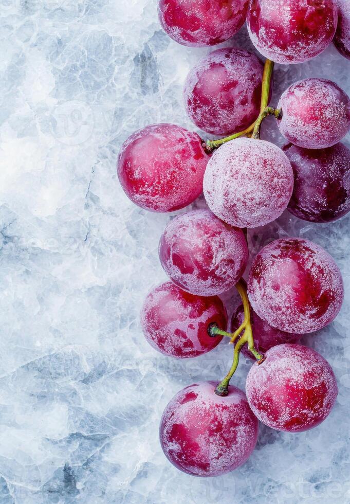 Frozen red grapes on a marble background photo