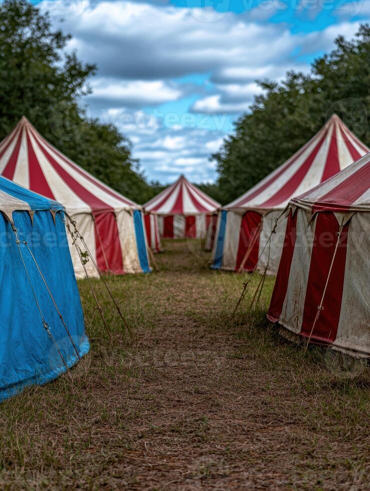 Colorful circus tents in a wooded field photo