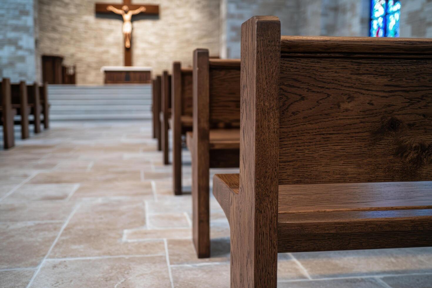 interior of a catholic church with wooden pews and crucifix photo