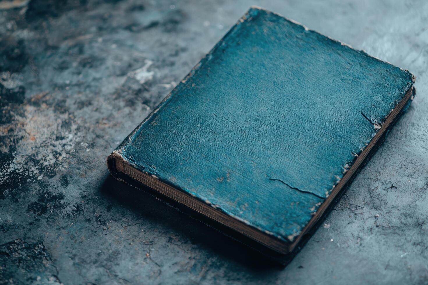 Weathered old book on a dark surface photo