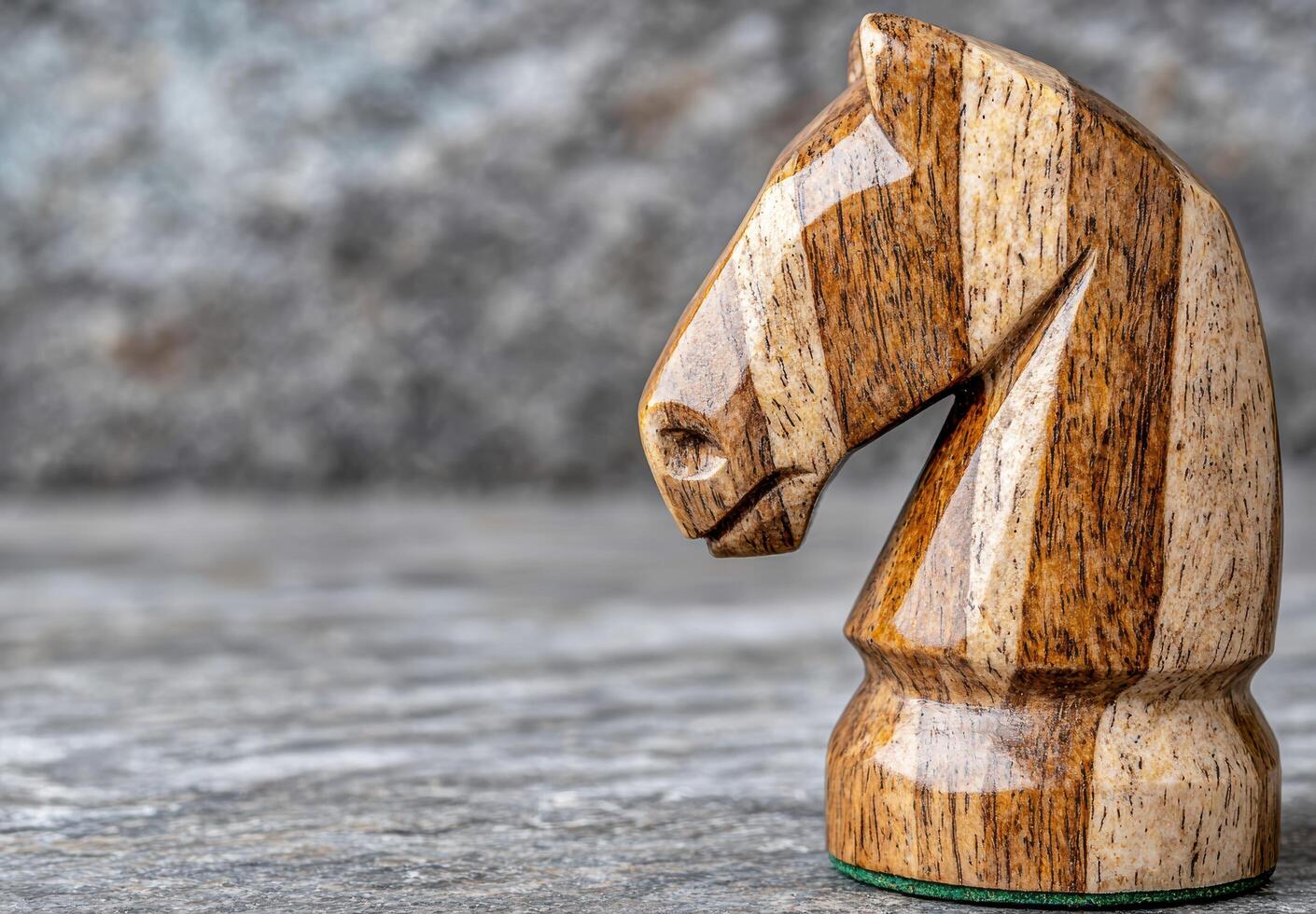 Carved wooden horse figurine on a gray background photo