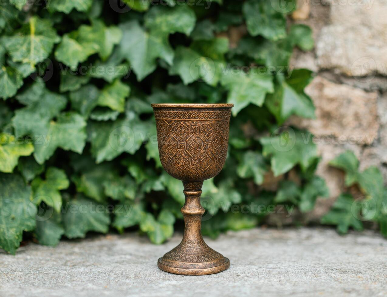 Ornate metal chalice in garden photo