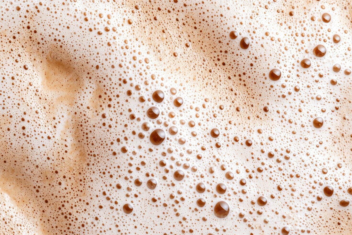 Close up of frothy beer or coffee foam photo