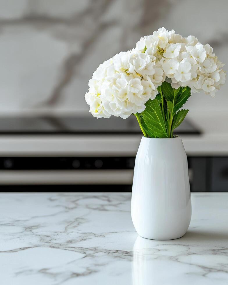 beautiful white hydrangea flowers in a vase on a marble table photo