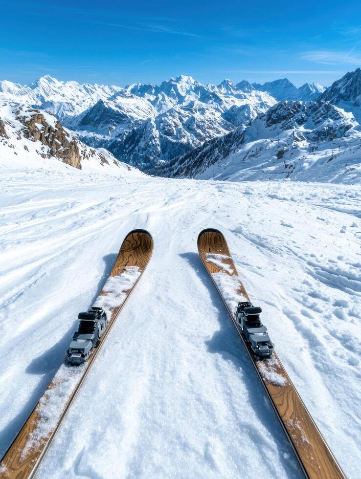 Scenic winter landscape with skis on snow covered mountain photo