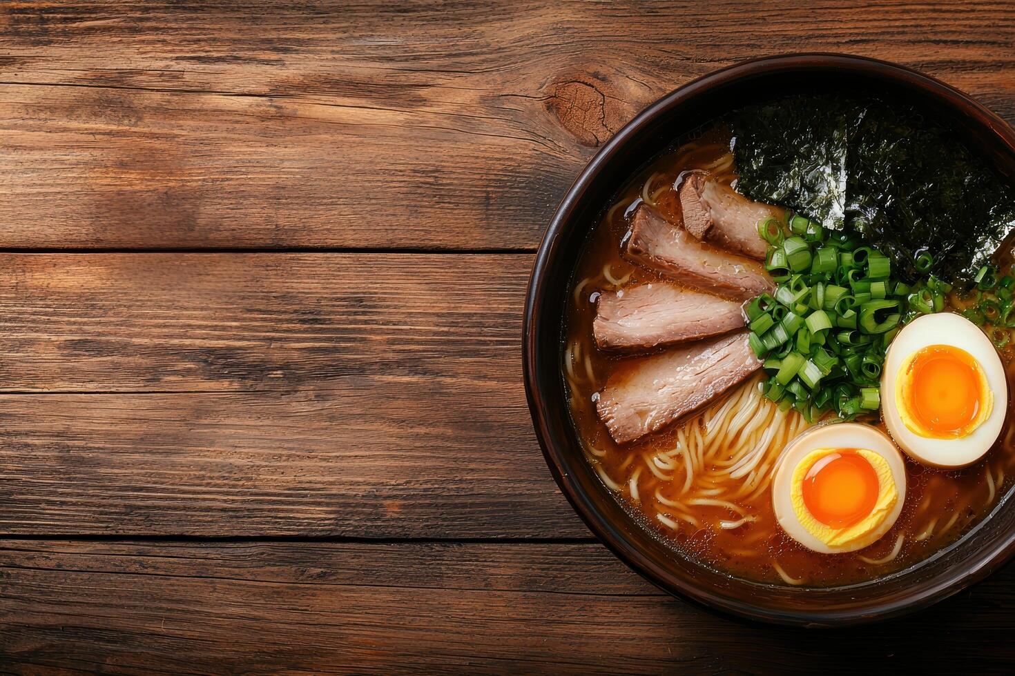 Delicious ramen noodle soup with pork, egg, and green onions photo
