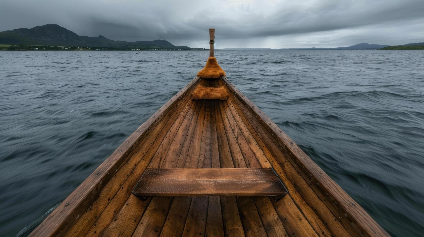 Wooden boat on a serene lake with mountains in the background photo