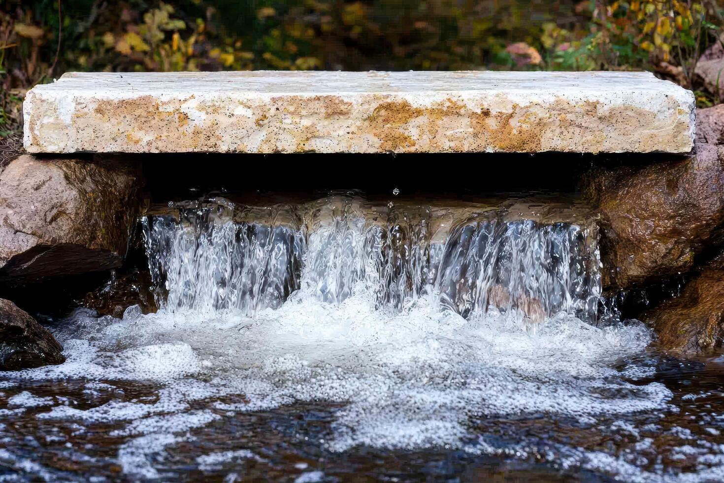 Cascading waterfall flowing over stone structure photo