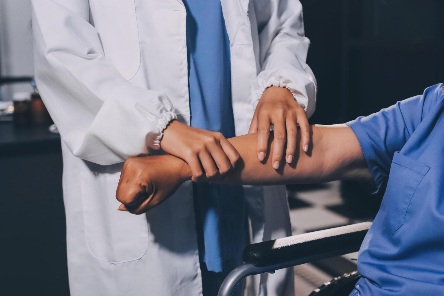 Doctor or Physiotherapist working examining treating injured arm of athlete male patient, stretching and exercise, Doing the Rehabilitation therapy pain in clinic. photo