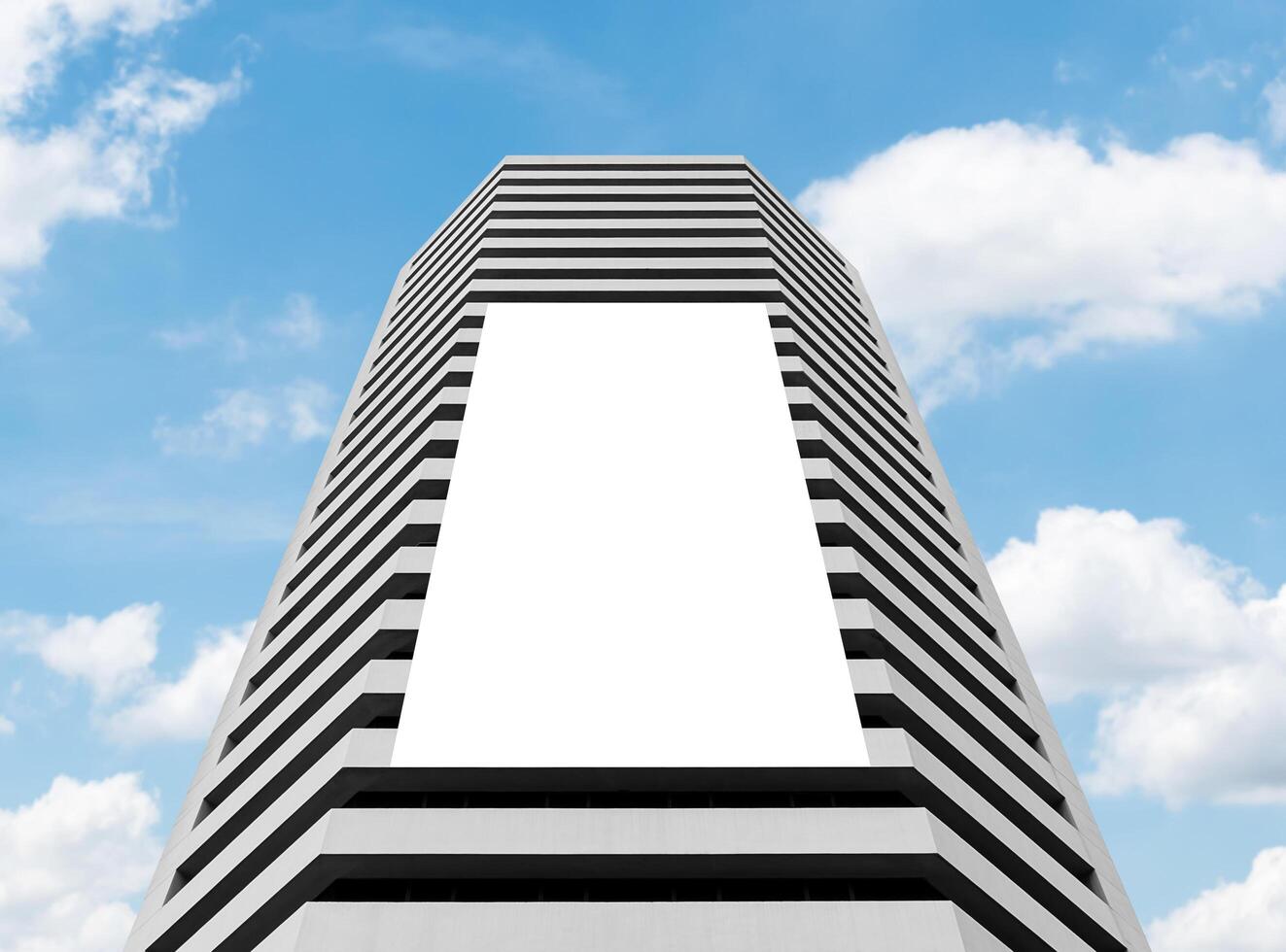 Mock up white vertical large LED display billboard on tower building. Clipping path for mockup photo