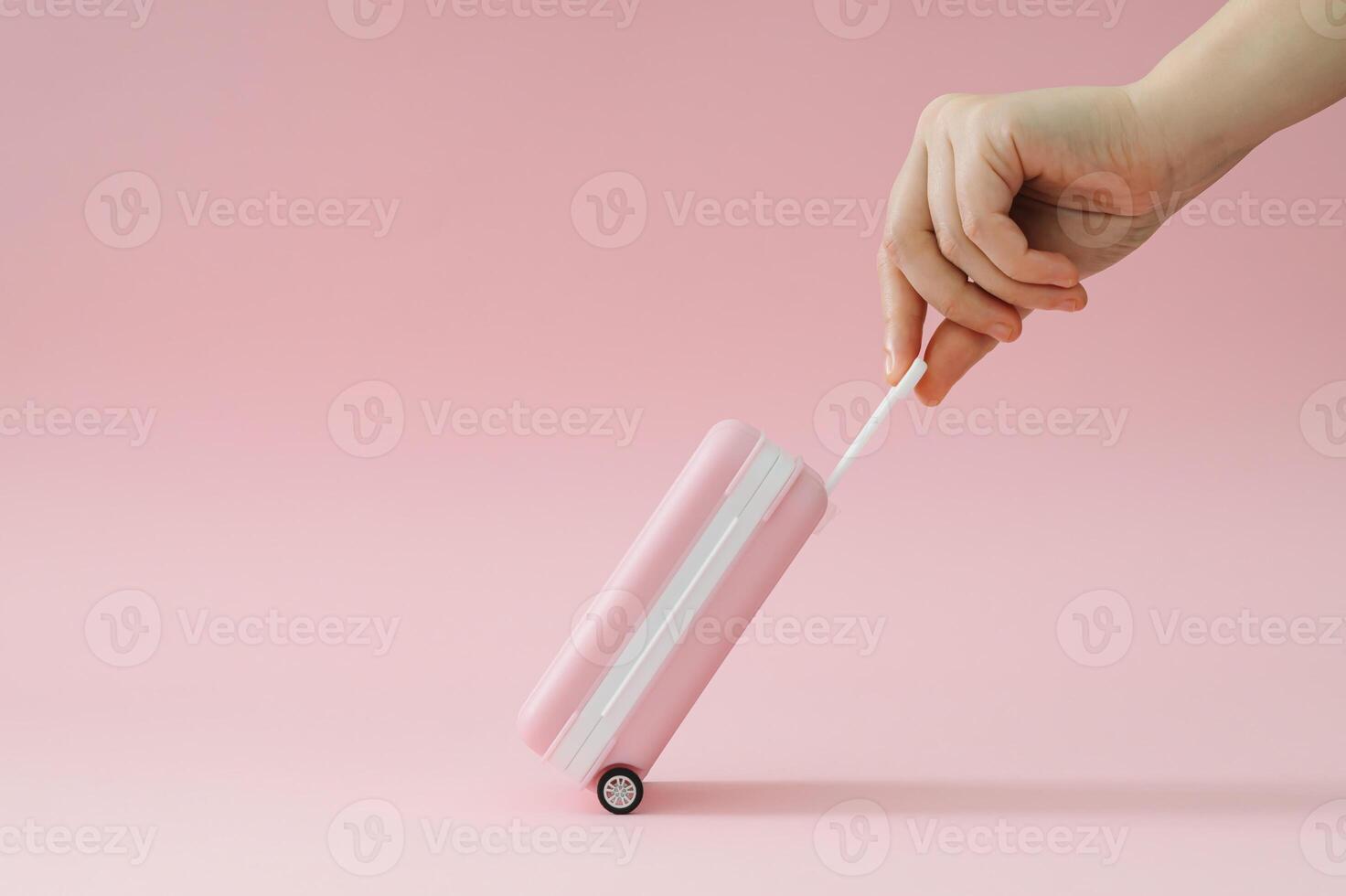 Creative trendy layout made with pink suitcase and woman's hand on pastel pink background. Minimal travel concept. Fancy vacation idea. photo