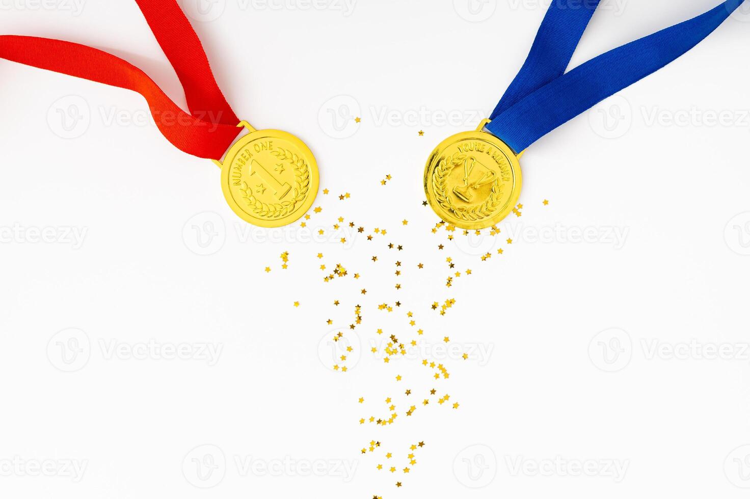 Golden medals on white background with golden glitter stars. Creative winner concept. Minimal victory backdrop idea. Flat lay. photo