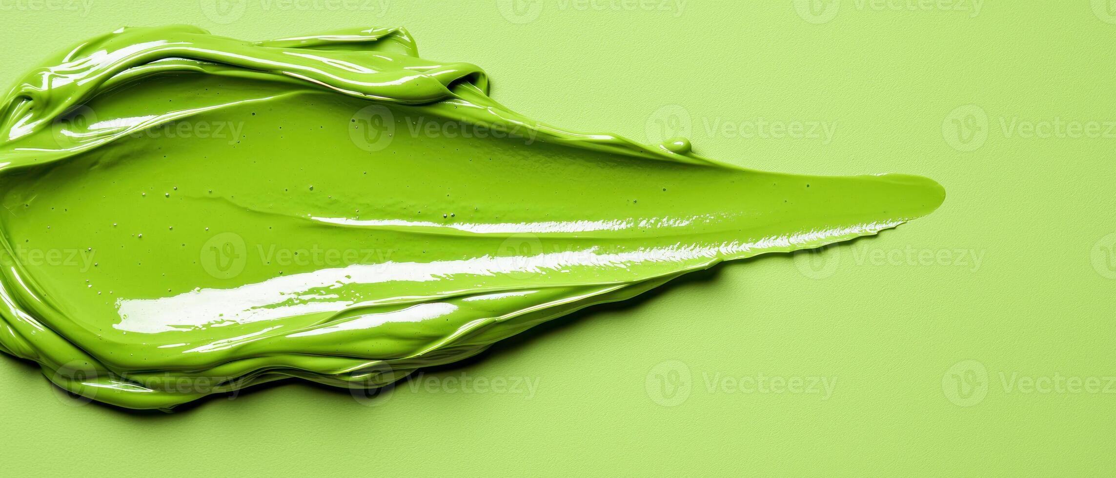 Vibrant green paint on a smooth surface, showcasing rich color and texture. photo