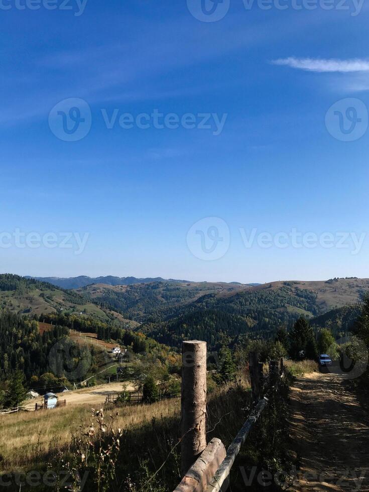 Scenic mountain landscape with dirt path and clear blue skies photo