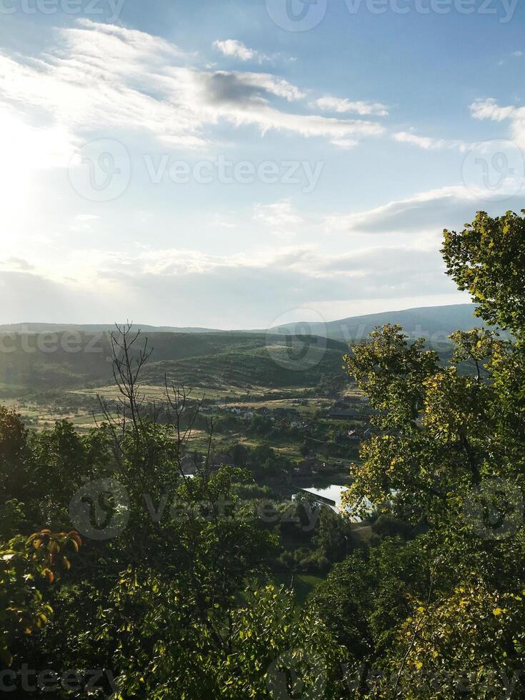 Scenic countryside landscape with rolling hills and lush greenery photo