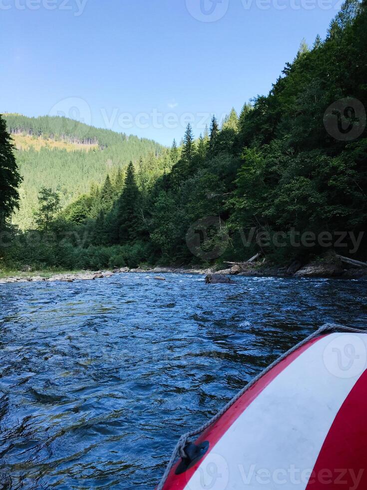 Scenic river rafting adventure through lush green forest landscapes photo