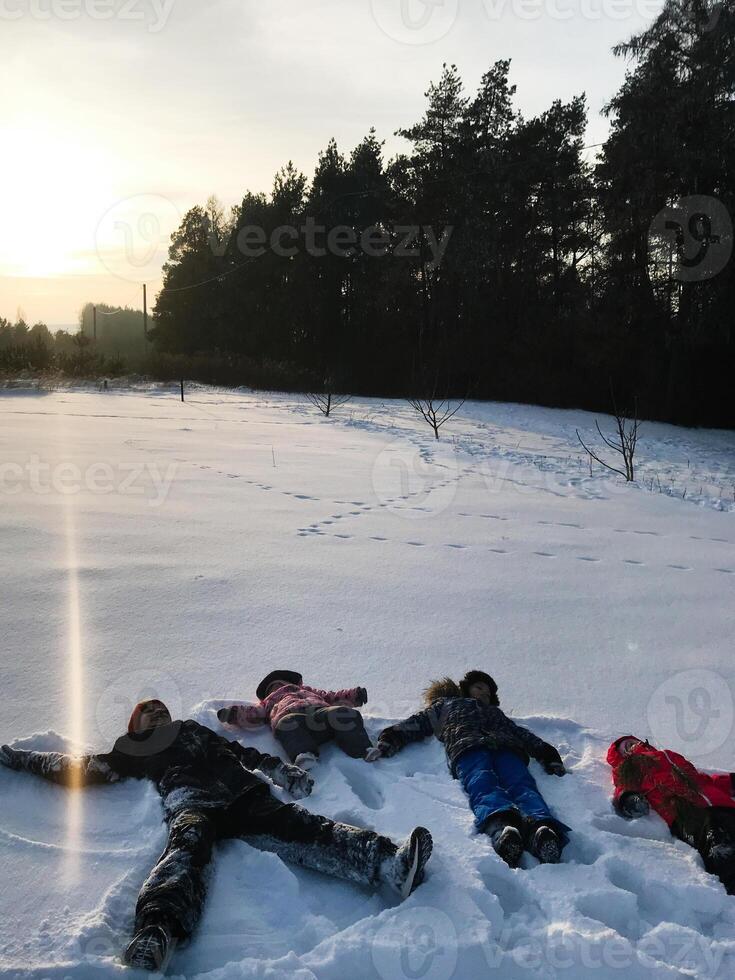 Children enjoying a playful day in the snowy landscape photo