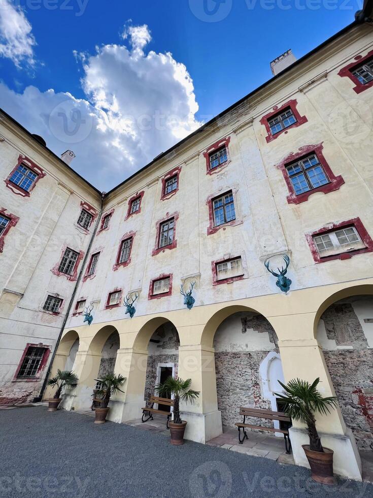 Majestic European building facade under a vibrant blue sky in Kunstat, Czech Republic. photo