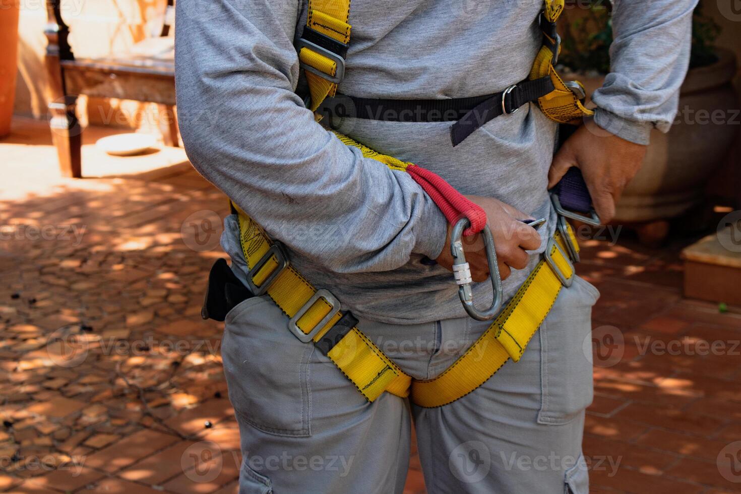 Man wearing a yellow safety harness photo