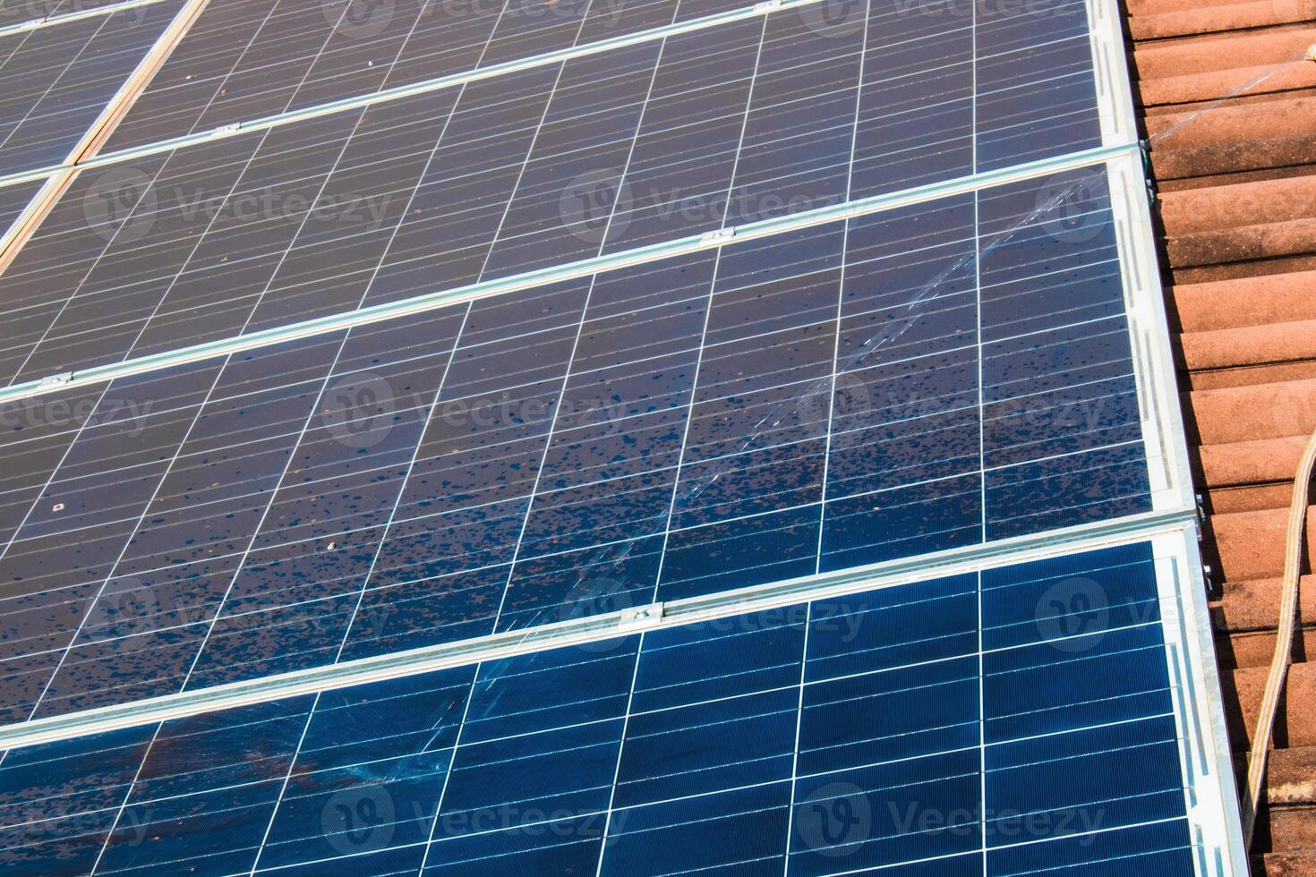 Solar worker cleaning photovoltaic panels with brush and water. Photovoltaic cleaning, before and after concept image. Space for text. photo